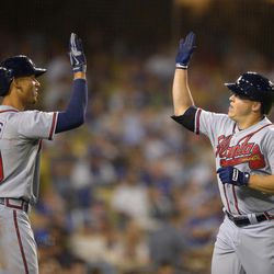 Atlanta Braves' Kris Medlen, right, his congratulated by Andrelton Simmons after hitting a solo home run during the fifth inning of a baseball game against the Los Angeles Dodgers, Saturday, June 8, 2013, in Los Angeles.  
