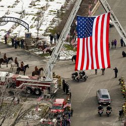 The funeral procession for Utah Highway Patrol trooper Eric Ellsworth arrives at the Brigham City Cemetery on Wednesday, Nov. 30, 2016.