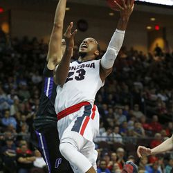 FILE - In this March 5, 2016, file photo, Gonzaga guard Eric McClellan (23) shoots over Portland guard Bryce Pressley during the first half of a West Coast Conference tournament NCAA college basketball game, in Las Vegas. McClellan’s scoring surge actually encompasses the whole month of March rather than just the NCAA Tournament. He averaged 20.3 points in three West Coast Conference tournament games to give Gonzaga an automatic NCAA berth. 