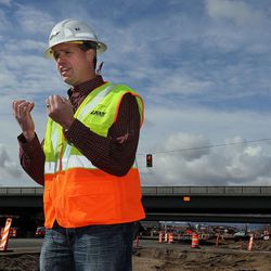 UDOT project manager Brett Slater talks with the media as crews prepare Wednesday, March 9, 2016, to slide a bridge into place on I-15 over Hill Field Road in Layton. The bridge is to be  Wednesday night and early Thursday morning.
