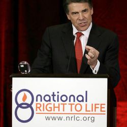 Governor Rick Perry addresses a large audience in attendance at the National Right To Life Convention Thursday, June 27, 2013, in Grapevine, Texas. The Republican has called a second special legislative session beginning July 1, allowing the GOP-controlled statehouse another crack at passing restrictions opponents say could shutter nearly all the abortion clinics across the state. (AP Photo/Tony Gutierrez)