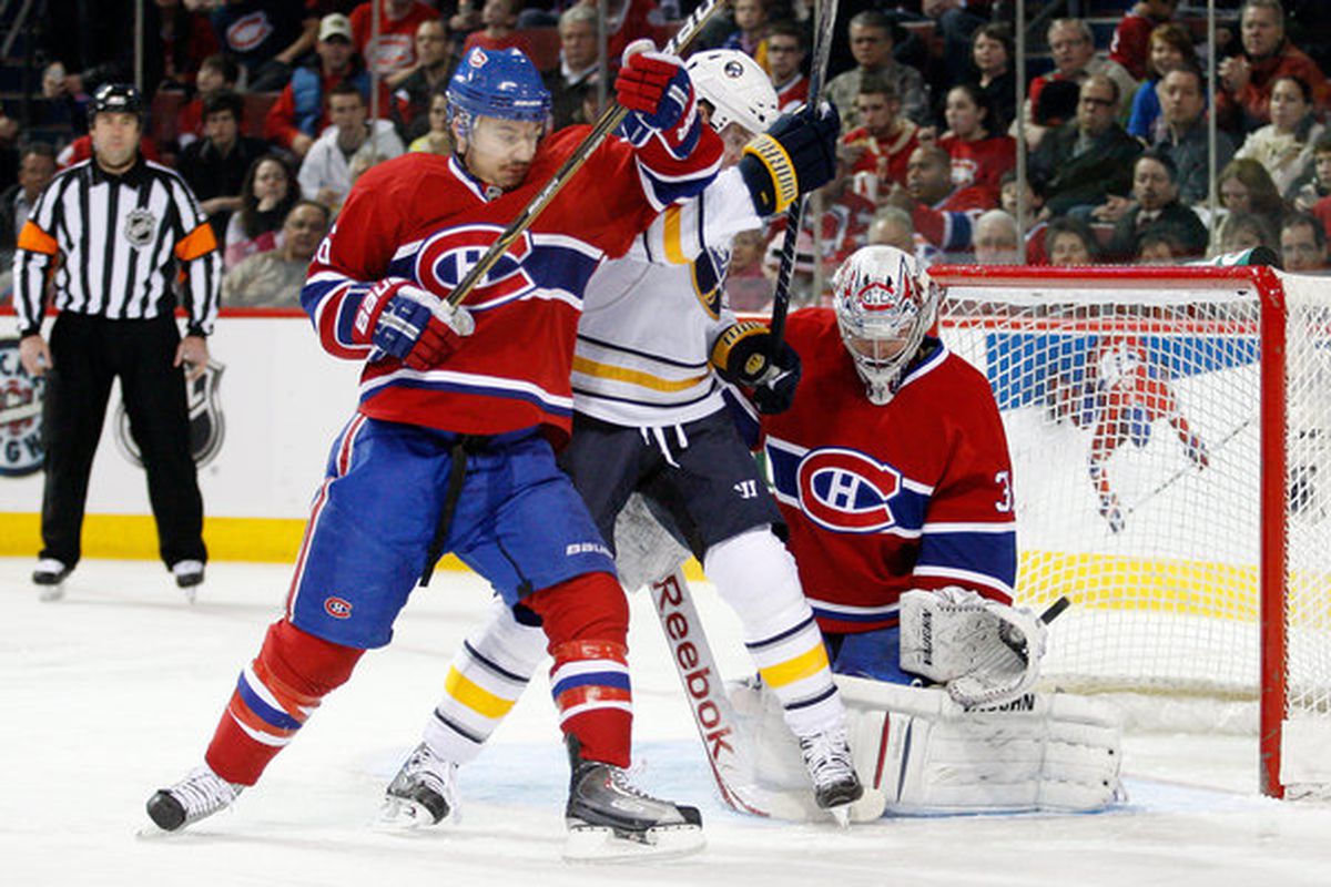 Josh Gorges ties up Sabres scorer Thomas Vanek in front of the Canadiens net.