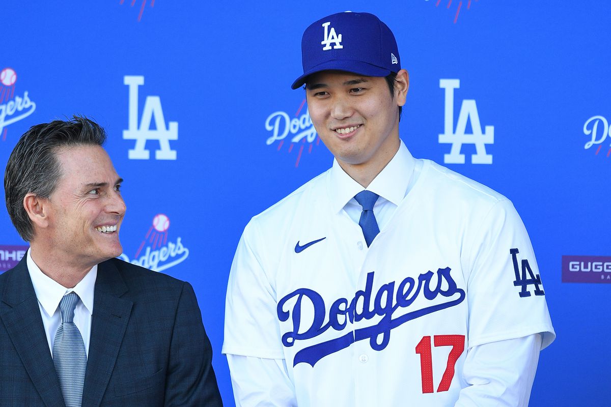 Newly acquired Los Angeles Dodgers designated hitter Shohei Ohtani poses for a picture with his agent from CAA Sports Nez Balelo as he is introduced at a press conference on December 14, 2023 at Dodger Stadium in Los Angeles, CA.