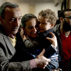 Nayerah Atef, an Egyptian crew member of the hijacked domestic EgyptAir flight, is hugged by her family members upon the flight arrival at Cairo International airport, Egypt, Tuesday, March 29, 2016. An Egyptian man wearing a fake explosives belt who hijacked a domestic EgyptAir flight and forced it to land in Larnaca Cyprus on Tuesday has surrendered and was taken into custody after he released all passengers and crew unharmed. 