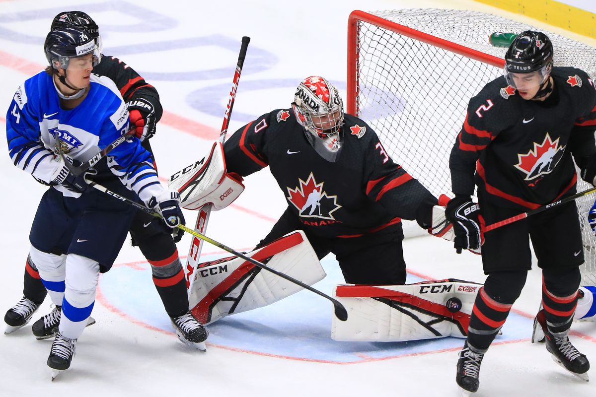 OSTRAVA, CZECH REPUBLIC - JANUARY 4, 2020: Finland’s Sampo Ranta (L) and Canada’s Kevin Bahl, goalie Joel Hofer (R-L) in their 2020 World Junior Ice Hockey Championship semifinal match at Ostravar Arena.
