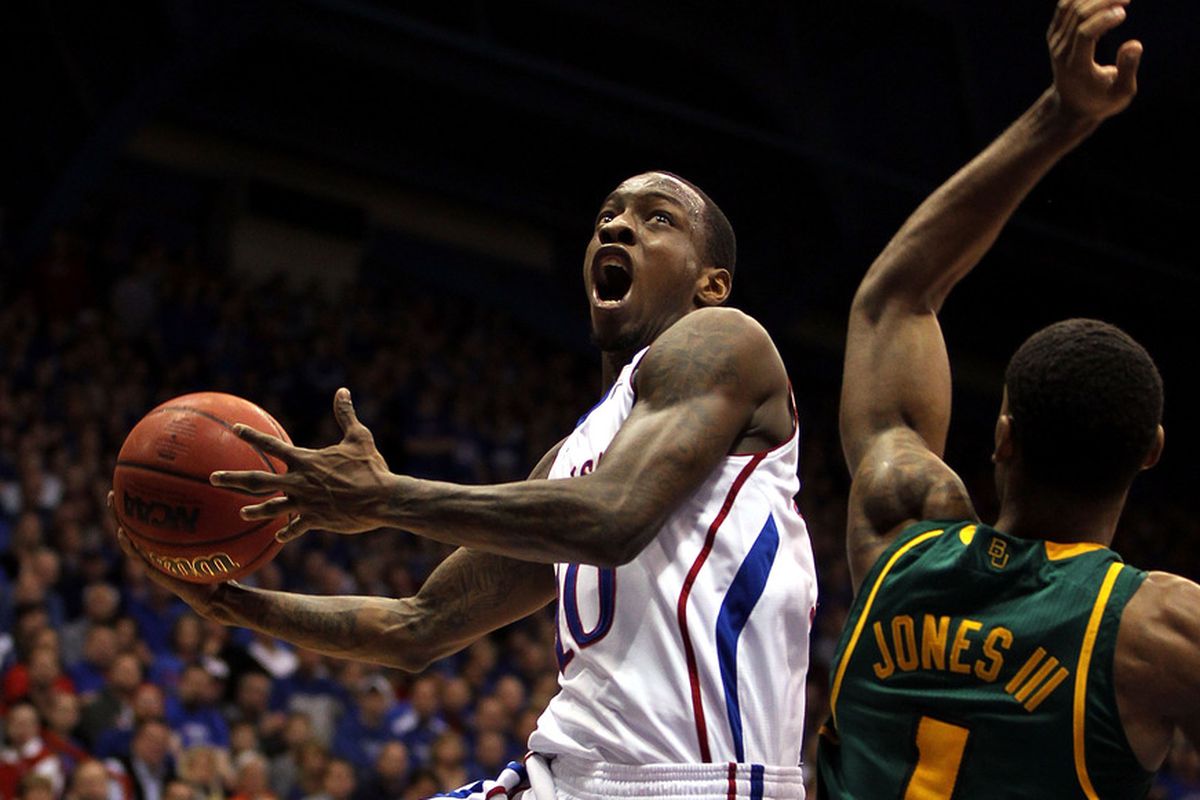 LAWRENCE, KS - JANUARY 16:  Tyshawn Taylor #10 of the Kansas Jayhawks shoots over Perry Jones III #1 of the Baylor Bears during the game on January 16, 2012 at Allen Fieldhouse in Lawrence, Kansas.  (Photo by Jamie Squire/Getty Images)