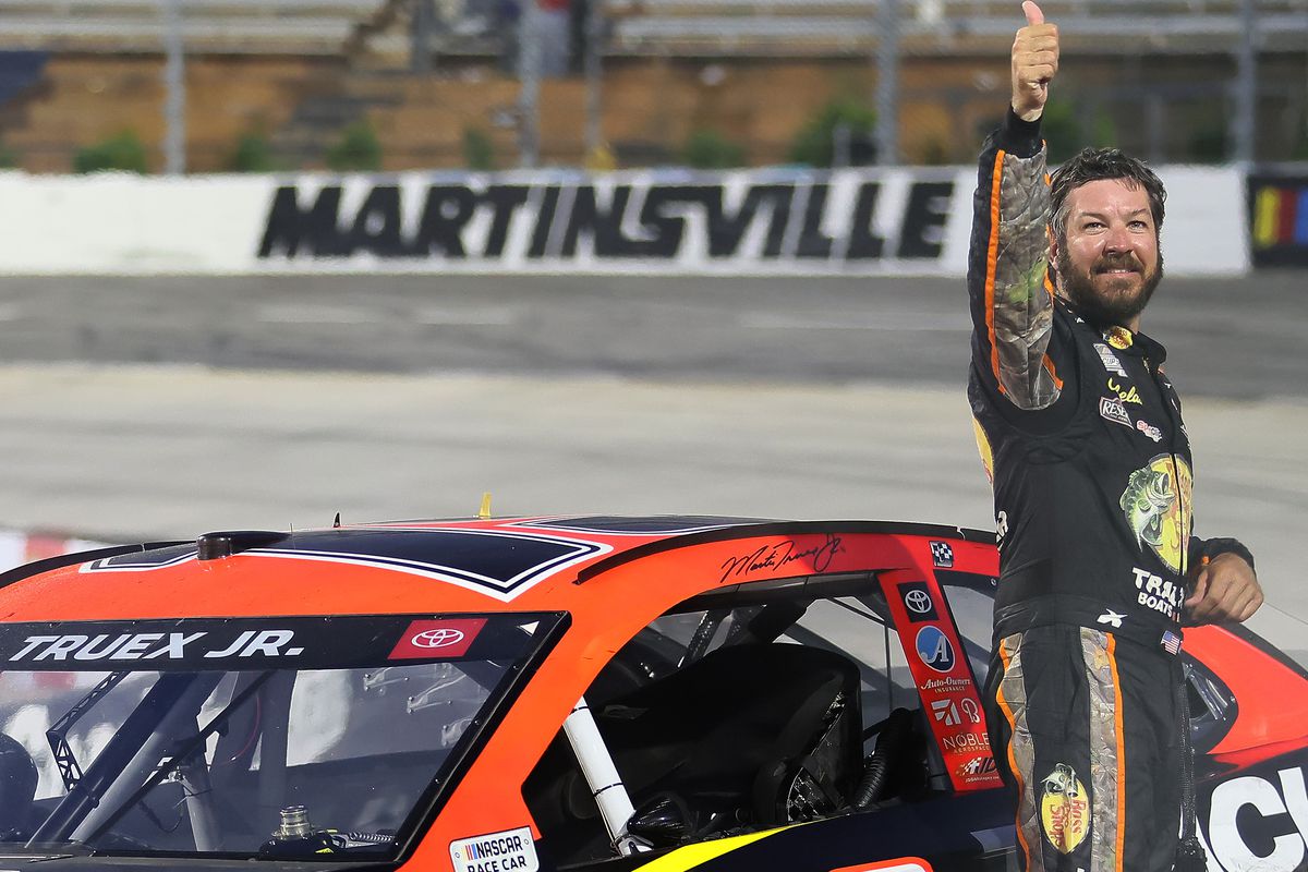 Martin Truex Jr., driver of the #19 Bass Pro Toyota, celebrates after winning the NASCAR Cup Series Blue-Emu Maximum Pain Relief 500 at Martinsville Speedway on April 11, 2021 in Martinsville, Virginia.