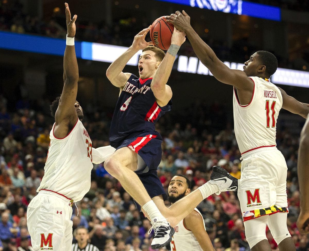 Belmont 's Dylan Windler, center, goes to the basket between Maryland 's Bruno Fernando, left, and Darryl Morsell (11) during the second half of the first round men's college basketball game in the NCAA Tournament in Jacksonville, Fla. Thursday, March 21,