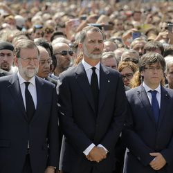 King Felipe of Spain, center, Prime Minister Mariano Rajoy, center left, and Catalonia regional President Carles Puigdemont, center right, observe a minute of silence in memory of the terrorist attacks victims in Las Ramblas, Barcelona, Spain, Friday, Aug. 18, 2017. Spanish police on Friday shot and killed five people carrying bomb belts who were connected to the Barcelona van attack that killed at least 13, as the manhunt intensified for the perpetrators of Europe's latest rampage claimed by the Islamic State group.