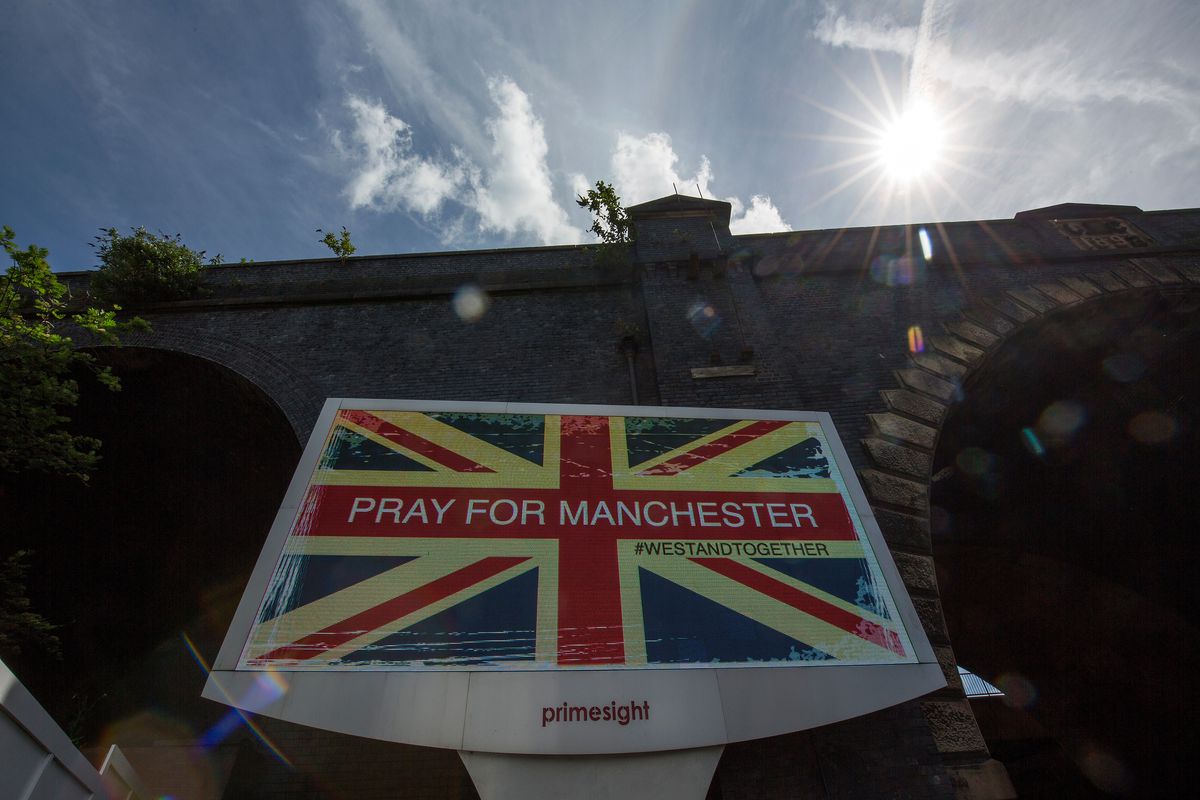A giant TV advertisement screen, next to a railway bridge, displays 'Pray For Manchester' after last nights terrorist attack, May 23, 2017 in Manchester, England.