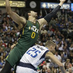 Utah Jazz center Enes Kanter (0) is fouled by Dallas Mavericks forward Chandler Parsons (25) during the first half of an NBA basketball game Wednesday, Feb. 11, 2015, in Dallas. (AP Photo/LM Otero)