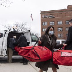 Roseland Hospital staff carry bags of food which is being donated by Robinson’s No. 1 Ribs to patients and staff at Roseland Hospital, Tuesday, March 31, 2020. | Tyler LaRiviere/Sun-Times