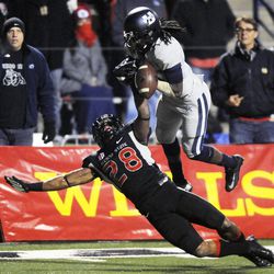 Utah State Aggies wide receiver Ronald Butler (18) is unable to hang on to the ball as Fresno State Bulldogs safety Charles Washington (28) defends during the Mountain West football championship game at Bulldog Stadium in Fresno, Calif., on Saturday, Dec. 7, 2013.