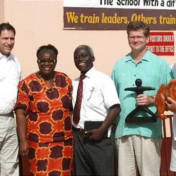 Steve Young stands next to Monica and Emmanuel Opare (executive directors of the Golden Sunbeam School), Sterling Tanner and John Shaffer with Rhino Sports.  Rhino Sports donated much of the cost associated with the Sport Court and the artificial turf field.