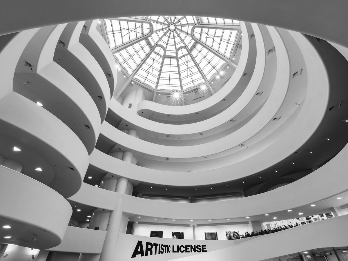 The interior of a museum building with a large spiral that takes up the entire space. It’s topped with a large window.