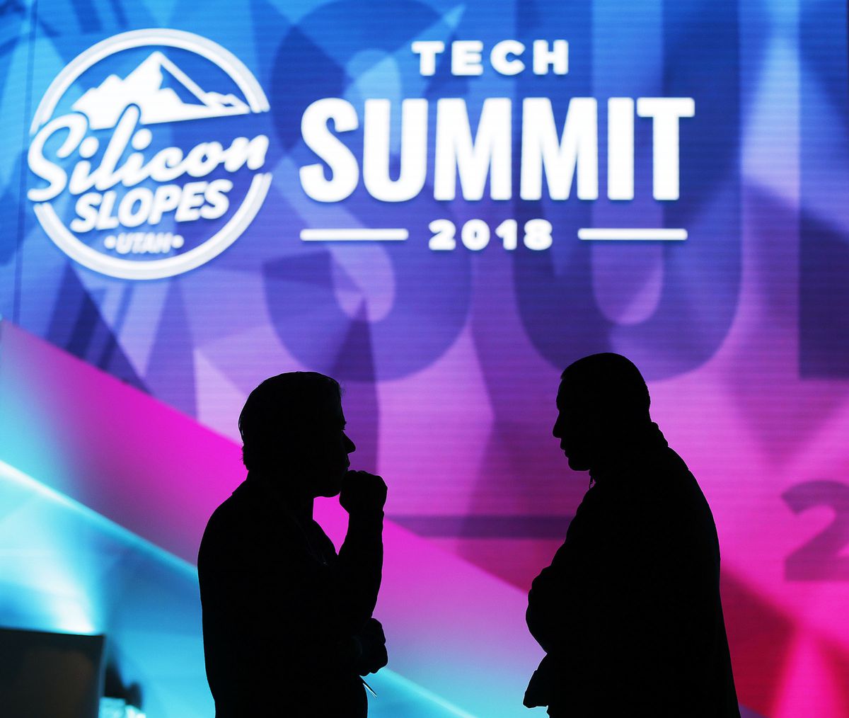 Bruce D Juhlin, left, and Mike Chao talk between sessions of the Silicon Slopes Tech Summit at the Salt Palace in Salt Lake City on Friday, Jan. 19, 2018.