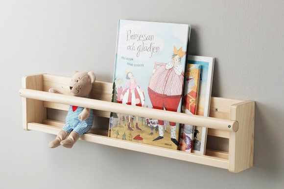Pale wood shelving with books and stuffed animals.