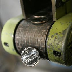The first Utah quarters spill from a conveyor belt on Monday at the U.S. Mint in Denver. They won't be released for circulation until Nov. 9. The mint makes 5 million to 8 million quarters a day in Denver.