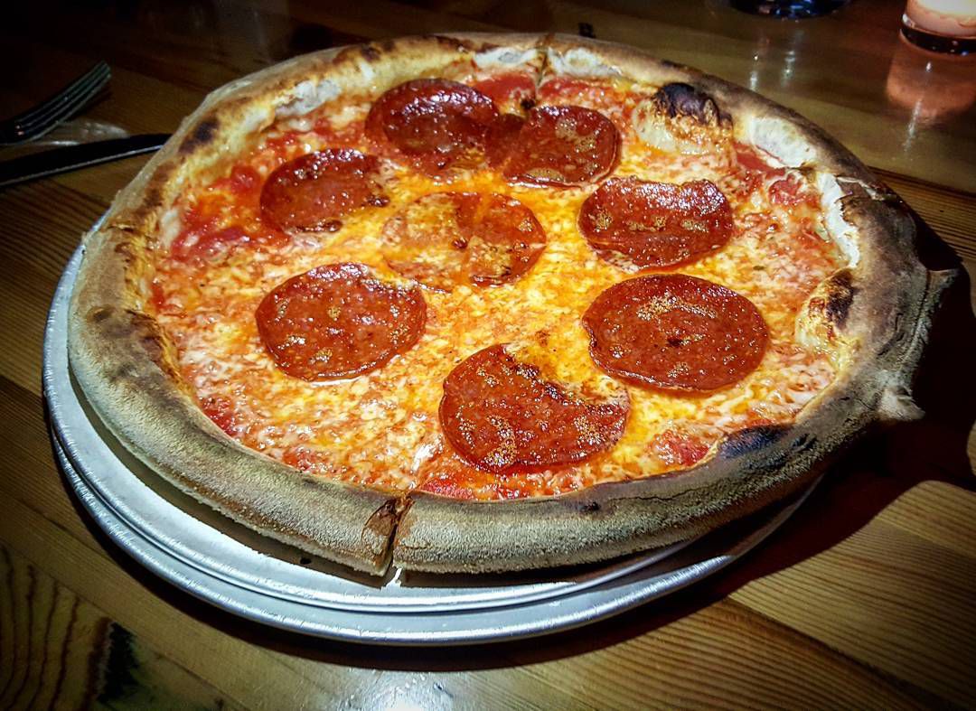 pizza covered with very large pepperonis
