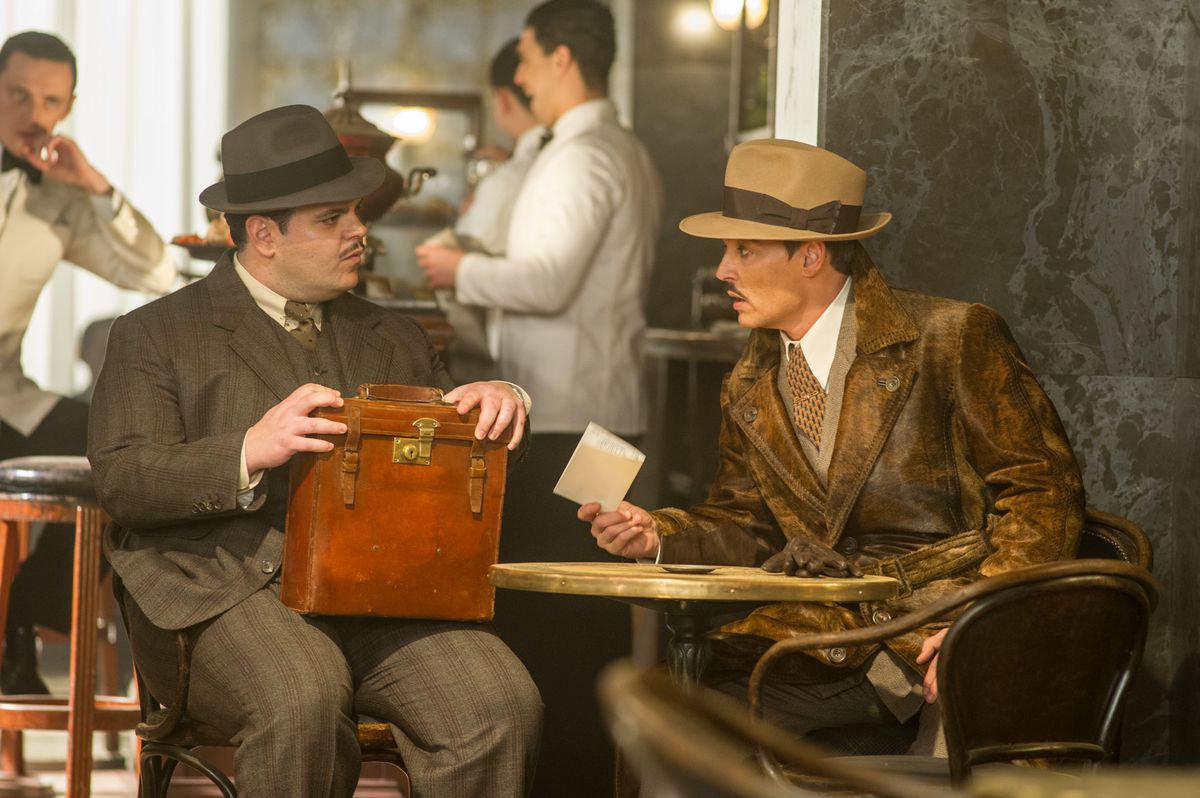 Josh Gad as Hector MacQueen and Johnny Depp as Edward Ratchett in Murder on the Orient Express.