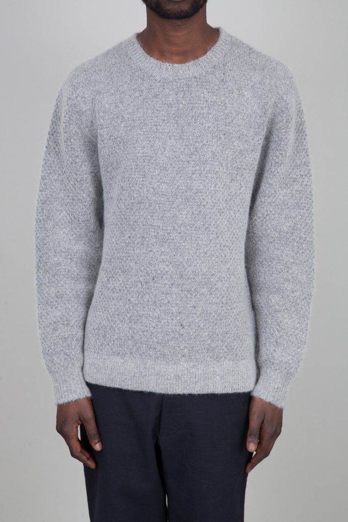 A male mode in a grey sweater