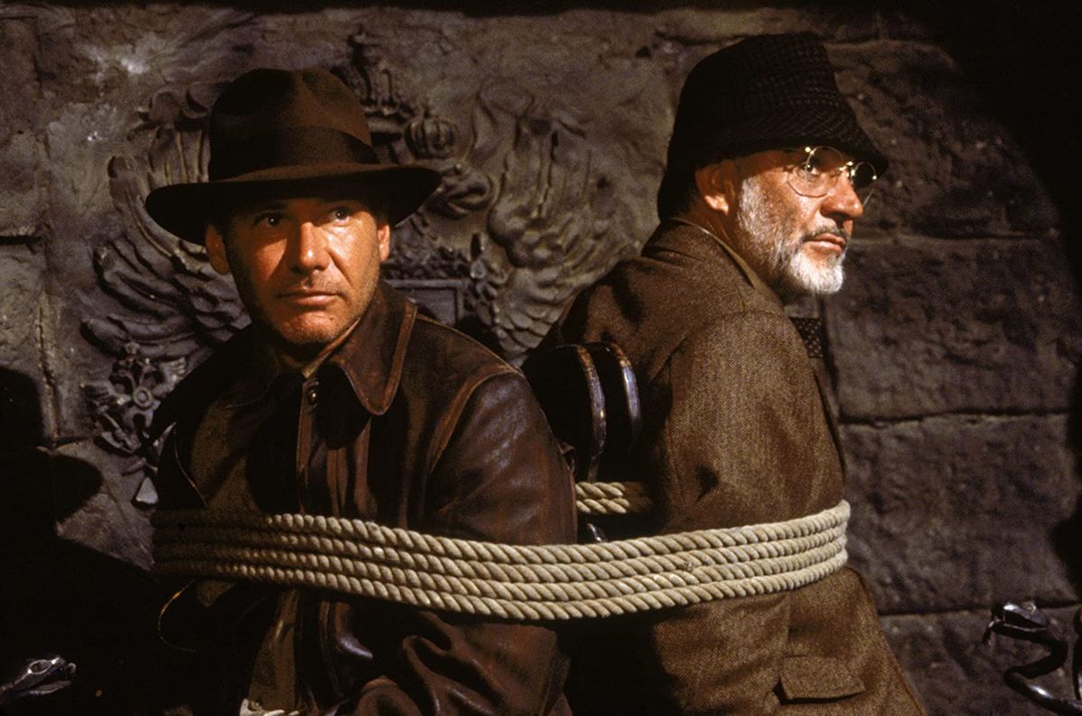 Indiana Jones (Harrison Ford) and Henry Jones (Sean Connery) are tied to a chair