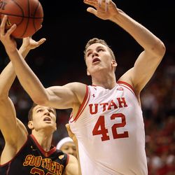 Utah Utes forward Jakob Poeltl (42) drives towards the rim as USC Trojans forward Nikola Jovanovic (32) tugs on his jersey during the Pac-12 Conference tournament quarterfinals at the MGM Grand Garden Arena in Las Vegas, Thursday, March 10, 2016.