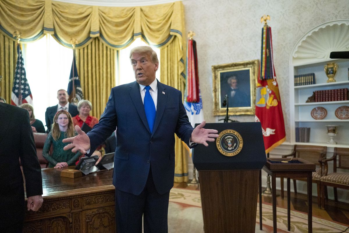 President Trump standing in the Oval Office.