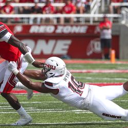 Utah quarterback Tyler Huntley (1) breaks free from Northern Illinois defensive end Quintin Wynne (10) during first-half action in the Utah-Northern Illinois football game at Rice-Eccles Stadium in Salt Lake City on Saturday, Sept. 7, 2019.