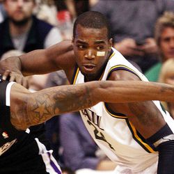 DeMarcus Cousins of Sacramento, left, and Paul Millsap, of Utah, reach for a loose ball as the Sacramento Kings face the Utah Jazz in NBA basketball in Salt Lake City, Friday, March 30, 2012.
