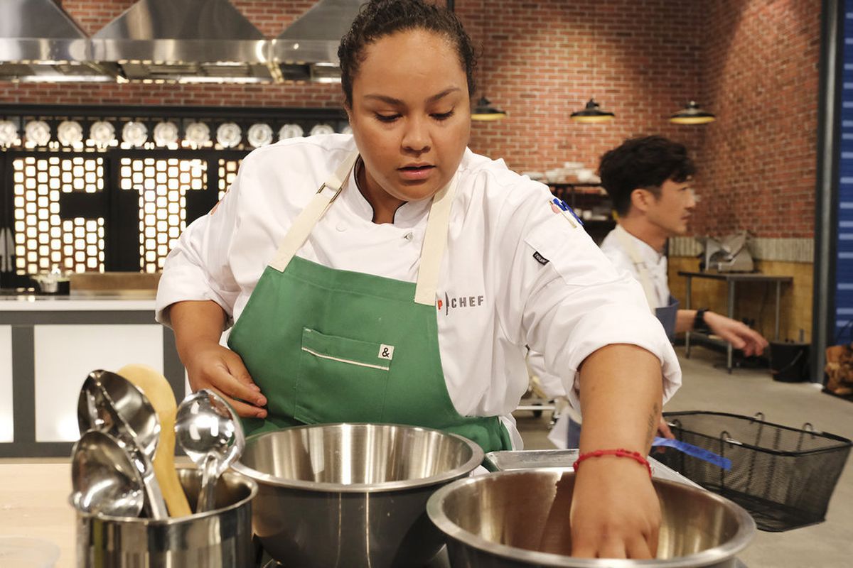 Houston chef Evelyn García reaches into a bowl during a challenge on “Top Chef Houston.”
