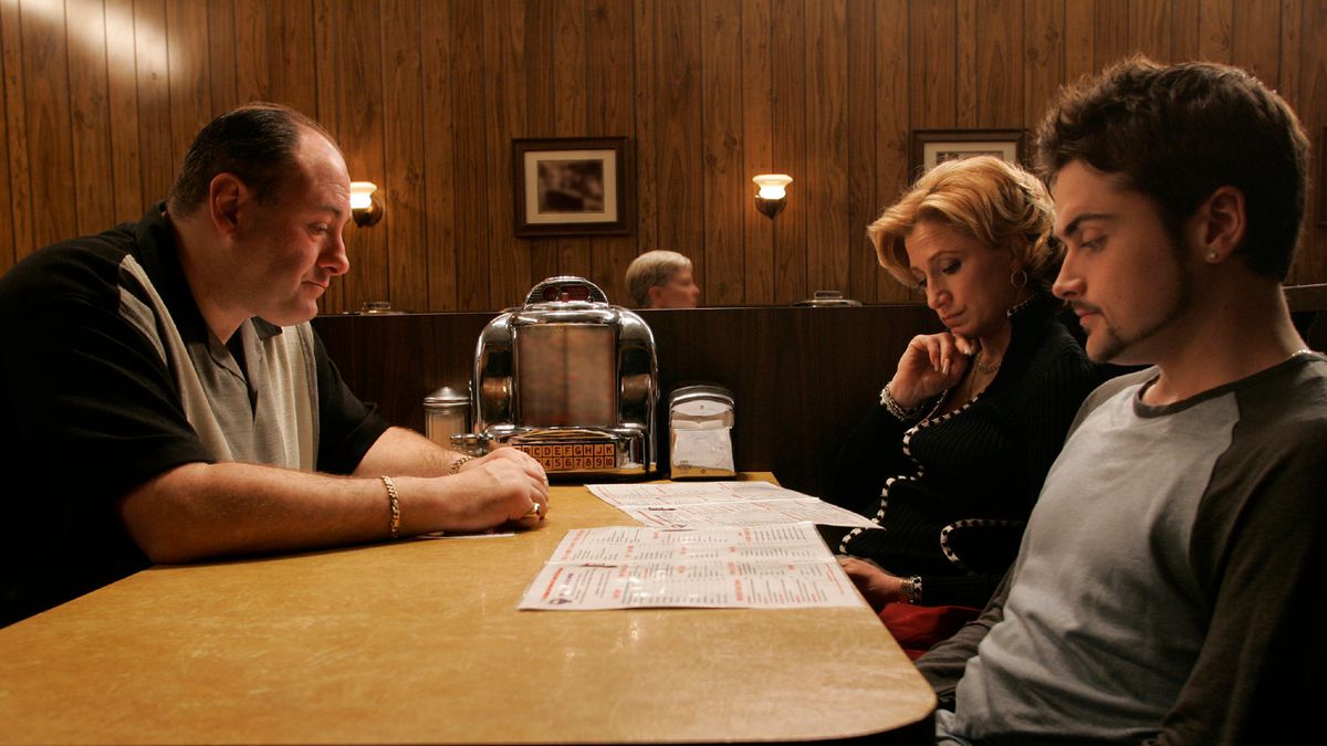Tony, Carmela, and AJ Soprano at a table in a diner.