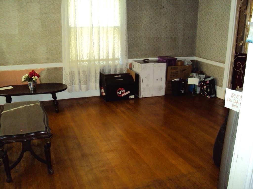 A small, dark room with boxes packed near the walls. 