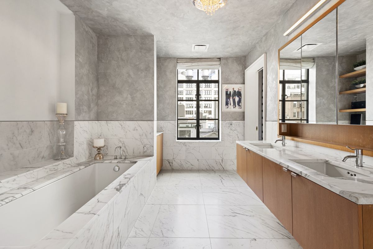 A marble bathroom with a window.