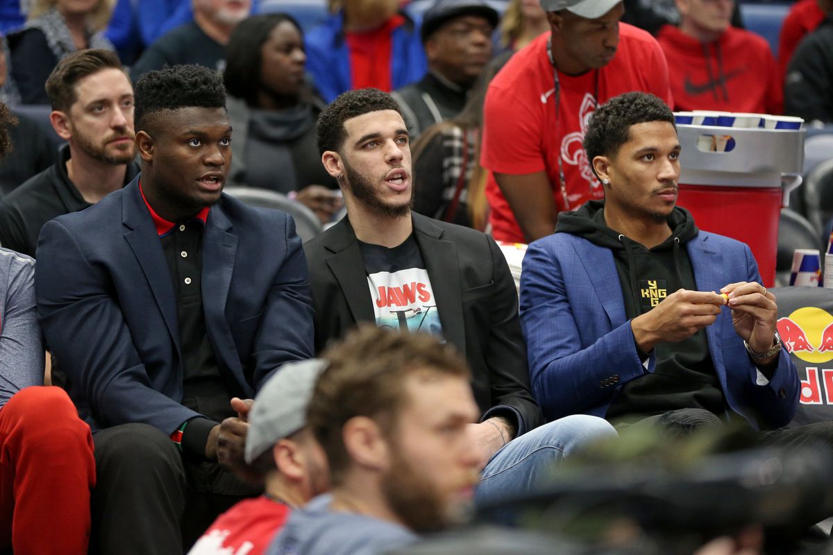 New Orleans Pelicans forward Zion Williamson and guards Lonzo Ball and Josh Hart watch a game against the Los Angeles Clippers from the bench in the first quarter at the Smoothie King Center.