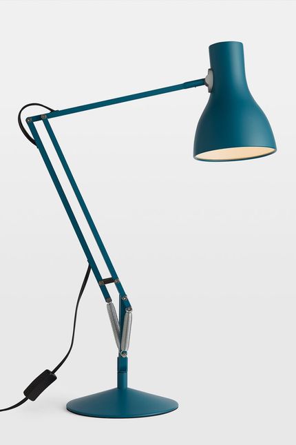 Blue lamp with flat round base and bent arms. 