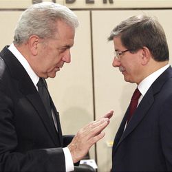 Greek Foreign Minister Dimitrios Avramopoulos, left, talks with Turkish counterpart Ahmet Davutoglu, during a NATO foreign ministers meeting at NATO headquarters in Brussels, Tuesday, April 23, 2013. NATO foreign ministers meet in Brussels to discuss the situation in Syria and Afghanistan. (AP Photo/Yves Logghe)
