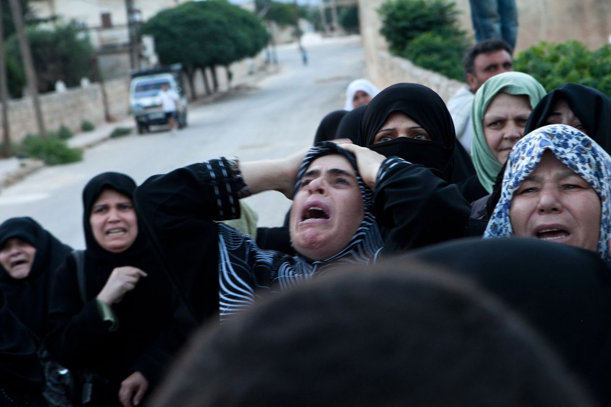 Syrian relatives mourn during the funeral of Mohammed Ahmed Rahim in Idlib province on June 22, 2012.
