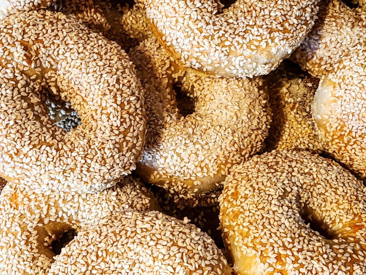 Several sesame bagels on top of each other.