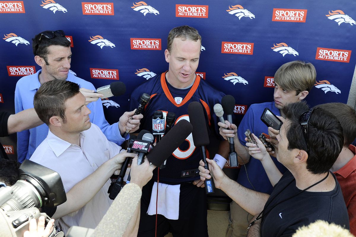 June 12, 2012; Englewood, CO, USA; Denver Broncos quarterback Peyton Manning (18) talks to the media following the end of minicamp at the Denver Broncos training facility. Mandatory Credit: Ron Chenoy-US PRESSWIRE