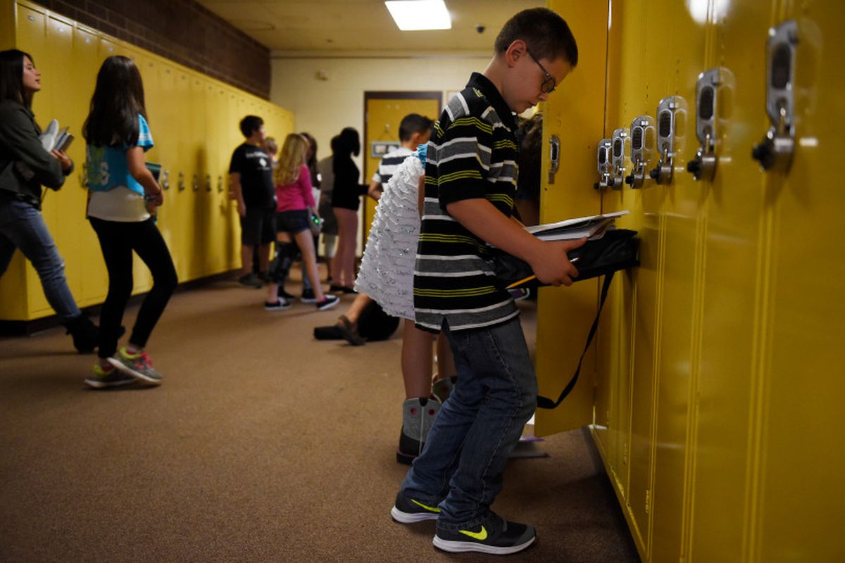 Ryan Kilburn checks his schedule before leaving a bank of lockers at Overland Trail Middle School on August 17, 2017, in Brighton, Colorado. (Photo by Seth McConnell/The Denver Post)