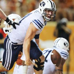 BYU's Taysom Hill flips the ball away after scoring a touchdown as BYU and Texas play Saturday, Sept. 6, 2014, in Austin Texas. BYU won 41-7.