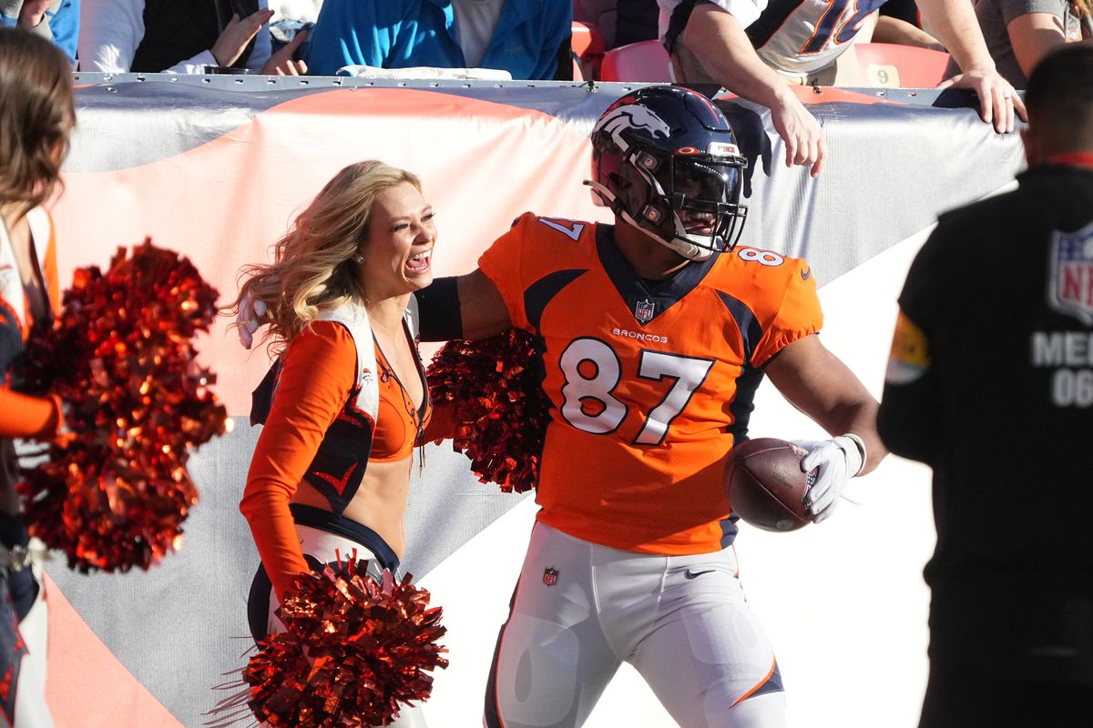 Denver Broncos tight end Noah Fant (87) reacts after running into a cheerleader following a reception prepares in the first quarter against the Detroit Lions at Empower Field at Mile High.&nbsp;