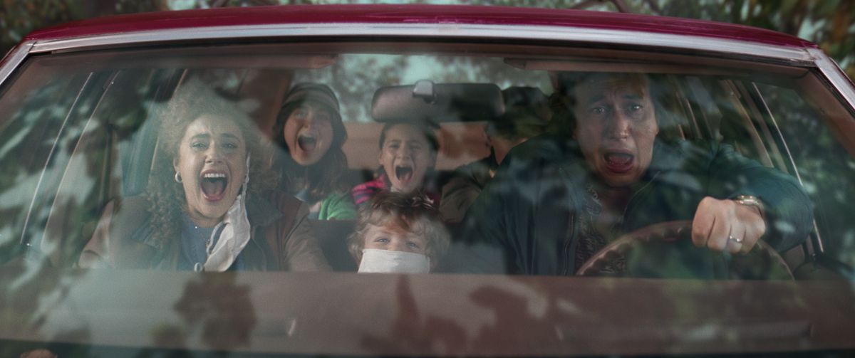 A family in a station wagon are screaming.