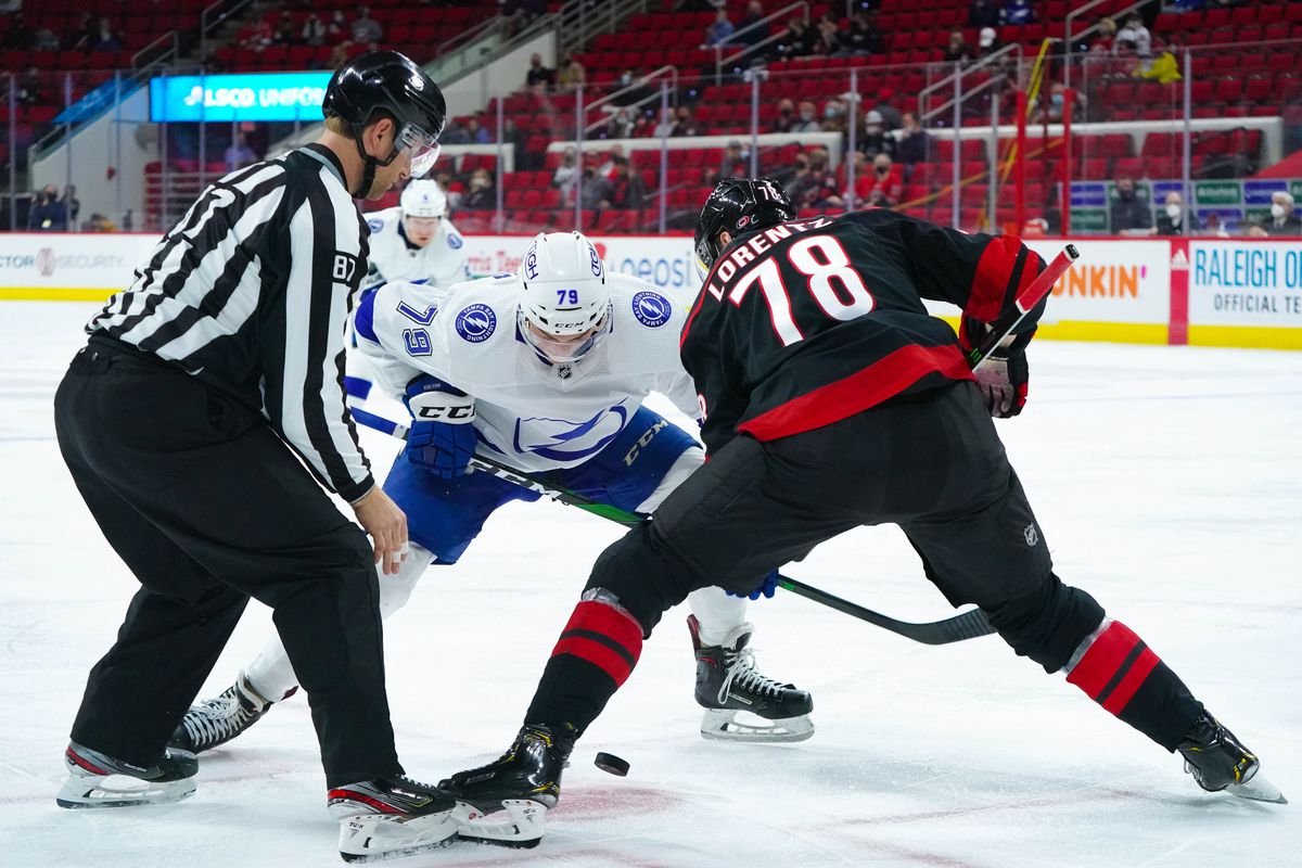 Tampa Bay Lightning left wing Ross Colton (79) takes a face off against Carolina Hurricanes left wing Steven Lorentz (78) at PNC Arena.