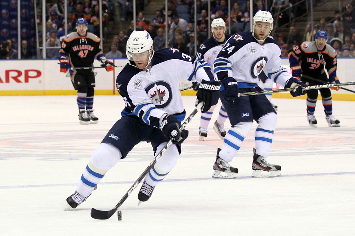 Apr 5, 2012; Uniondale, NY, USA;   Winnipeg Jets defenseman Mark Flood (36) turns the puck during the first period against the New York Islanders at Nassau Veterans Memorial Coliseum.  Mandatory Credit: Anthony Gruppuso-US PRESSWIRE