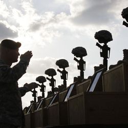 In this Nov. 10, 2009 file photo, soldiers salute as they honor victims of the Fort Hood shooting at a memorial service at Fort Hood, Texas. The Army said in a letter addressed to Congress on Friday, Feb. 6, 2015 that the victims of the 2009 shooting that left 13 dead and more than 30 wounded will receive the Purple Hearts many have said they deserve.