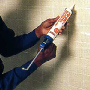 <p><strong>3. Apply Silicone Adhesive</strong></p> <p>Begin by applying continuous beads of silicone adhesive to the entire wall in a gridwork of horizontal and vertical stripes. Space the beads about 6 in. apart and apply a double bead of silicone along the top and bottom of the wall, which will provide extra holding power. Next, use a plastic trowel with 1/8-in.-wide notches to spread the silicone across the wall.</p>