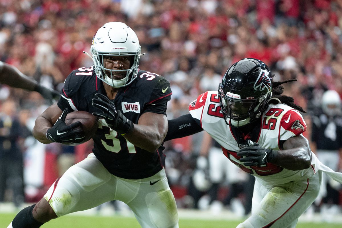 David Johnson of the Arizona Cardinals carries the ball against De’Vondre Campbell of the Atlanta Falcons during the NFL game at State Farm Stadium on October 13, 2019 in Glendale, Arizona.