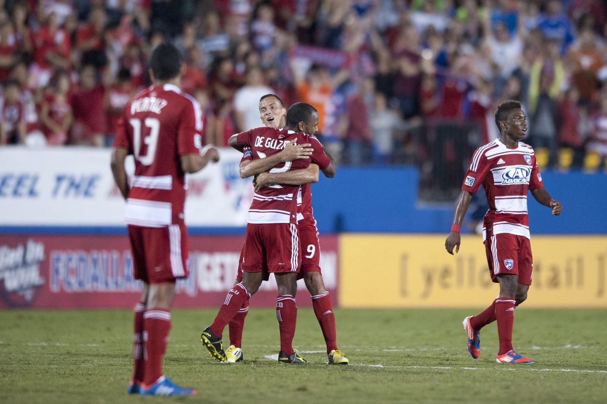 FRISCO, TX - SEPTEMBER 15:  Julian de Guzman #12 of FC Dallas celebrates the game winning goal with teammates against the Vancouver Whitecaps FC on September 15, 2012 at FC Dallas Stadium in Frisco, Texas.  (Photo by Cooper Neill/Getty Images)